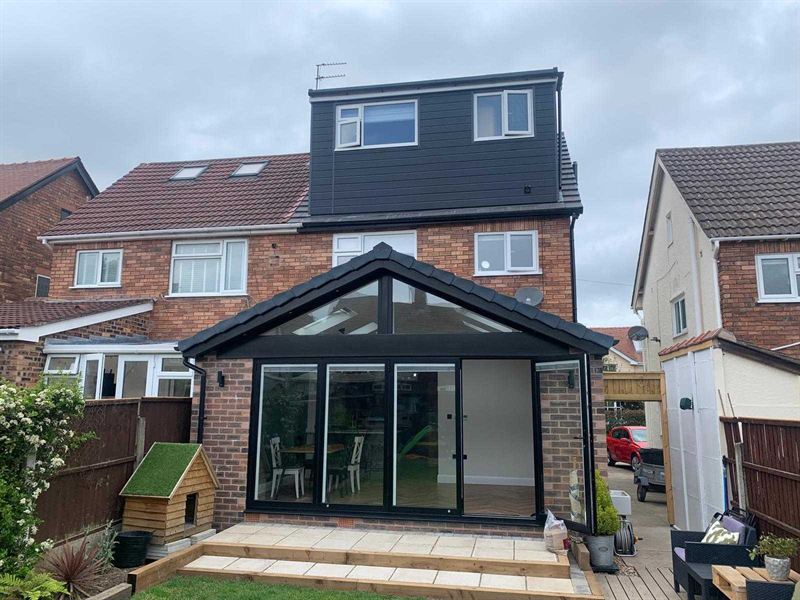 Brick rear extension with a pitched roof lantern and bi-fold doors onto a paved patio
