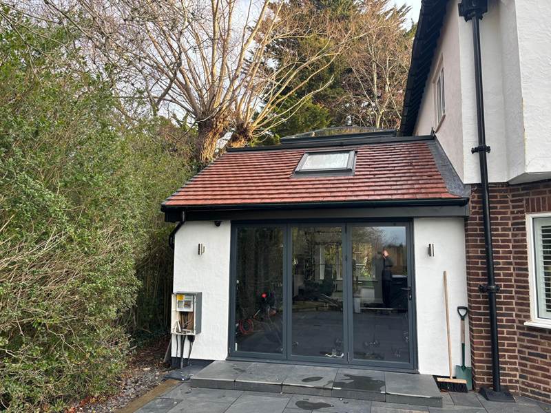 Completed single storey extension with anthracite bi-fold doors, a clay tiled roof and a roof window