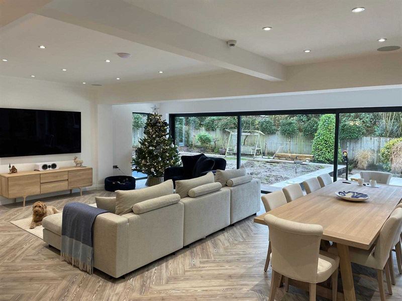 Open plan living and dining space inside a rear extension, with sliding doors onto the garden