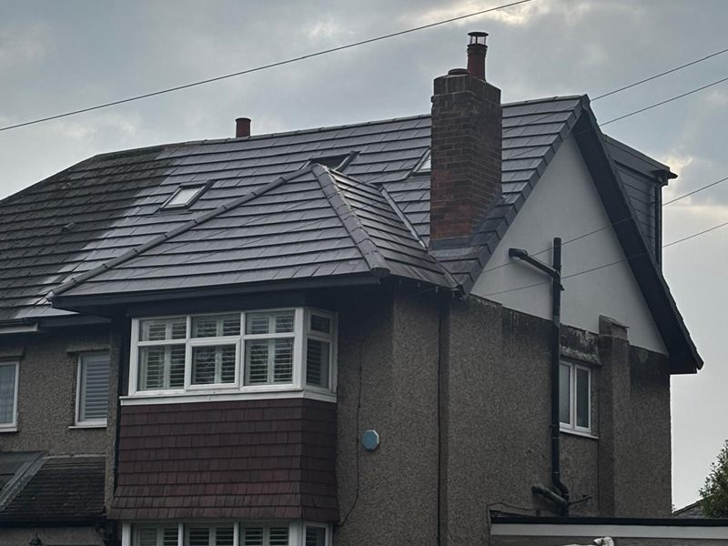 Semi detached house with a finished loft conversion, a new dark tiled roof and a rendered gable to the rear