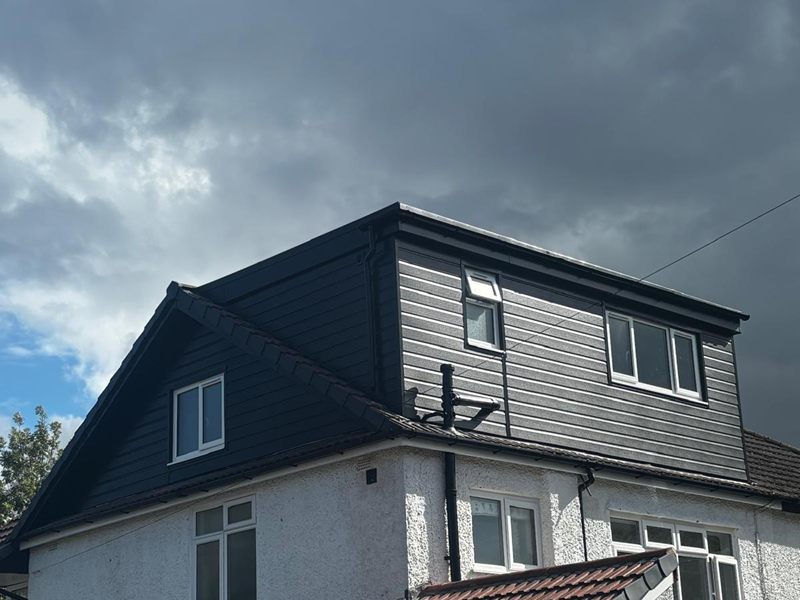Completed loft conversion on a Heswall semi with a dark clad dormer and a new gable end
