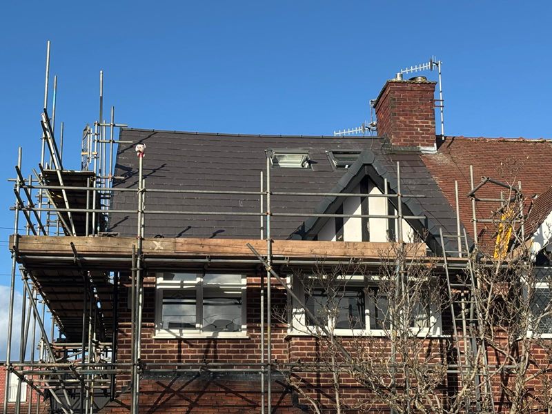 Newly tiled roof with rooflights on a loft conversion, photographed from the scaffold
